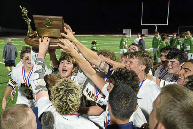 The Mars boys lacrosse team hoists the championship trophy following the team's 9-6 victory over South Fayette in the 2026 WPIAL Class 2A boys lacrosse championship game Thursday, May 21, 2026, at Upper St. Clair. (Andrew Palla | For TribLive)
