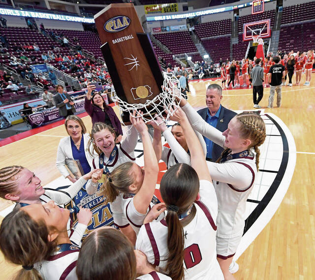 The Greensburg Central Catholic girls basketball team celebrates with the state championship trophy after defeating Holy Redeemer in the PIAA Class 3A final on March 19 at Giant Center in Hershey. (Christopher Horner | TribLive)