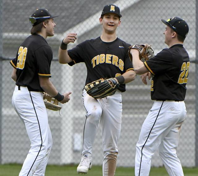 North Alleghenys JJ Mancuso celebrates with Mason Dratfinsky (left) and Jake Fritz after defeating Norwin on March 25. (Christopher Horner | TribLive)