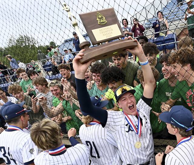 Butler’s Nolan Stefaniak hoists the WPIAL championship trophy with teammates and fans after defeating North Allegheny in the Class 6A final on Wednesday, May 27, 2026, at EQT Park. (Christopher Horner | TribLive)