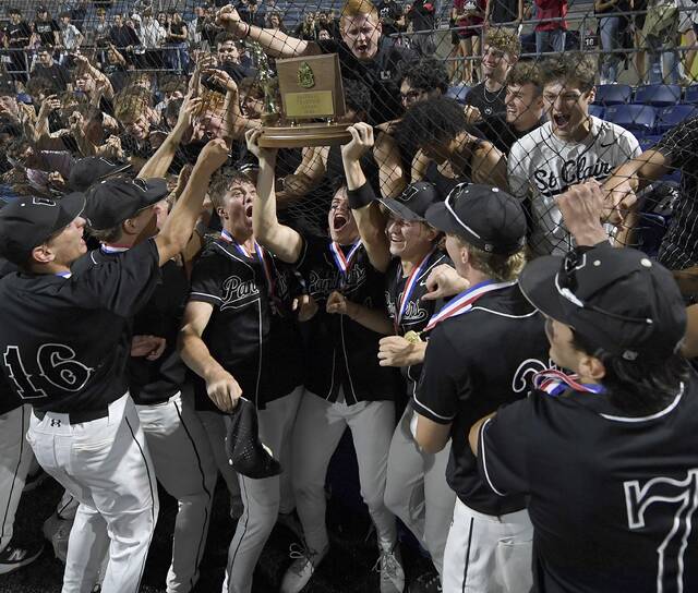 The Upper St. Clair baseball team celebrates with the WPIAL championship trophy after defeating South Fayette in the Class 5A final on Wednesday, May 27, 2026, at EQT Park. (Christopher Horner | TribLive)