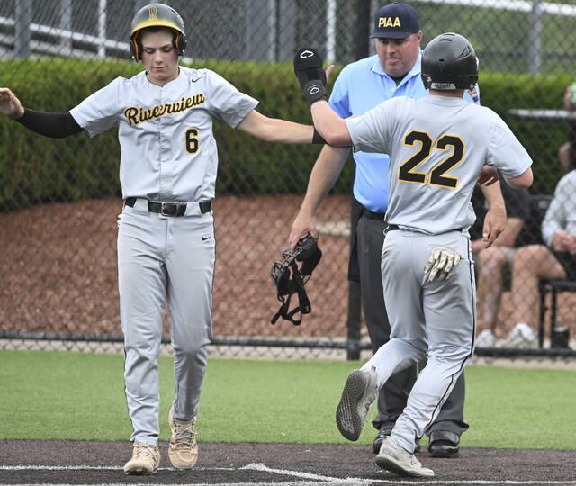 Riverviews Rex Roberts celebrates with Owen Orbich after Orbich scores against South Side during the WPIAL Class 2A third-place game Tuesday at Ross Memorial Park. (Chaz Palla | TribLive)