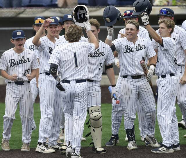 Butlers Boden Lenyk (1) is greeted by teammates after hitting a two-run homer against North Allegheny during the WPIAL Class 6A championship game Wednesday at EQT Park. (Christopher Horner | TribLive)