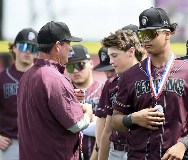 Greensburg Central head coach John Boyle presents runner-up medals to Carson Kramer and his teammates after the WPIAL Class A championship game against Eden Christian on May 26, 2026, at EQT Park. (Christopher Horner | TribLive)