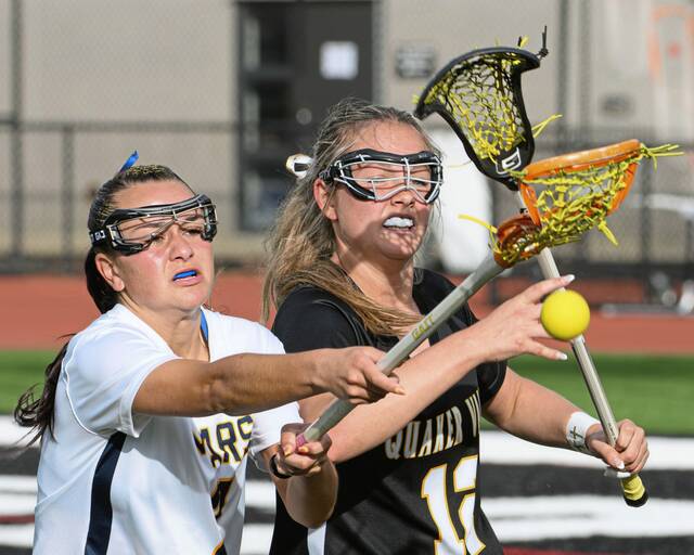 Mars' Madelyn Peterson and Quaker Valley's Annabel Miko fight for a loose ball during the WPIAL Class 2A girls lacrosse championship game Thursday, May 21, 2026 at Upper St. Clair. (Andrew Palla | For TribLive)